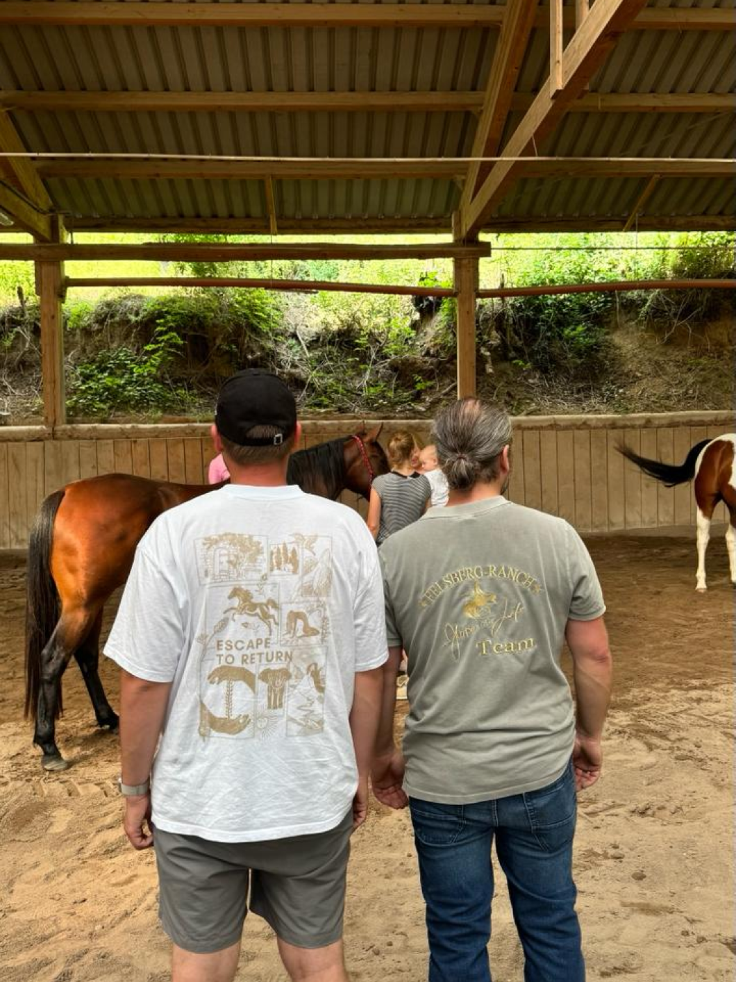 Family with horses in stable