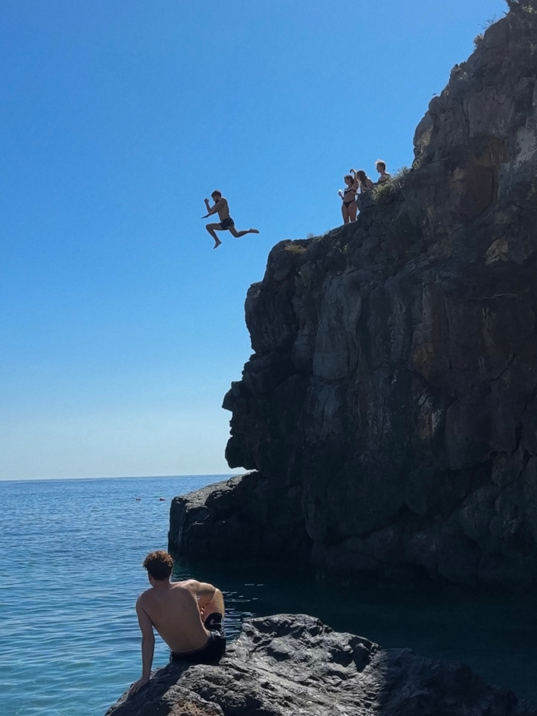 Cliff jumping into the sea